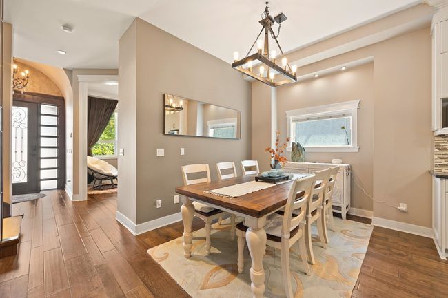 Dining room with a chandelier, wood finished floors, and recessed lighting | Image 6