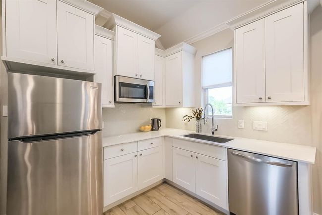 The guest suite features the SAME FINISHES AS THE MAIN KITCHEN and has full size appliances, all of which convey with the home. | Image 19