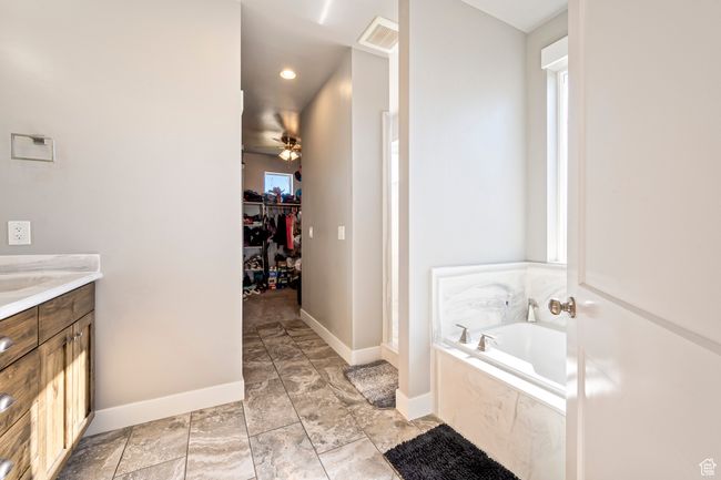 Full bathroom with visible vents, a bath, baseboards, a ceiling fan, and vanity | Image 19