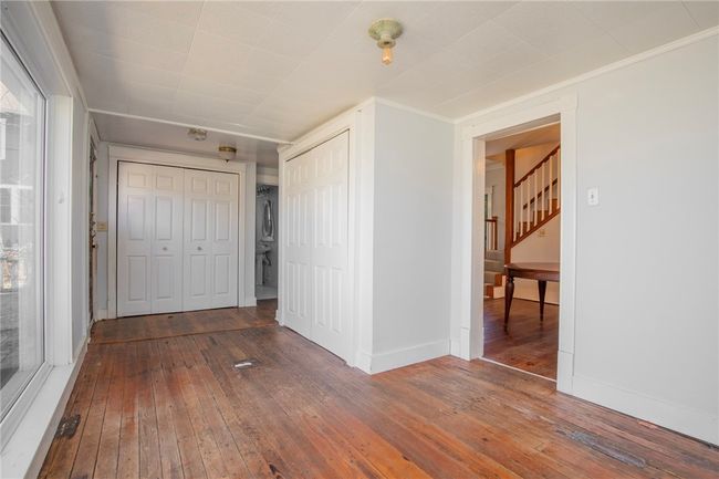 Sunroom with laundry on back of the house. | Image 10