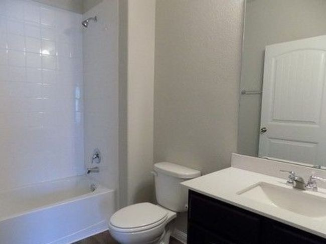 Bathroom with vanity, toilet, and washtub / shower combination | Image 13
