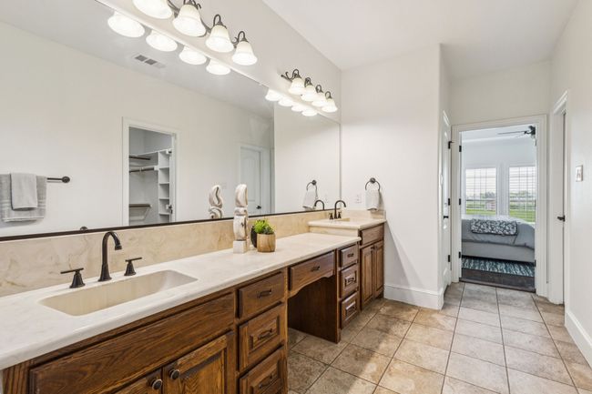 The large vanity features dual sinks and has plenty of space for both of you! | Image 23