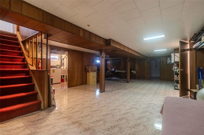 Finished basement with stairway and wooden walls | Image 25