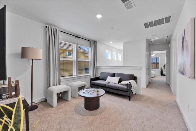 Living area featuring baseboards, attic access, visible vents, and carpet flooring | Image 4