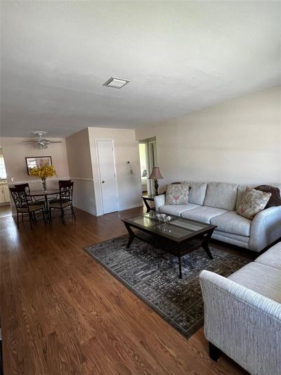 Living/Dining Room with entrance to Kitchen and Den past Dining Room | Image 2