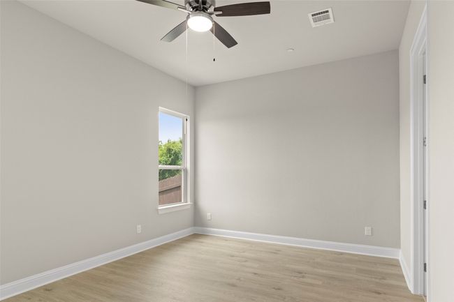 Spare room featuring baseboards, light wood-style flooring, and a ceiling fan | Image 22