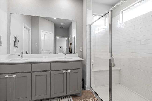 Bathroom with a shower stall and double vanity | Image 10
