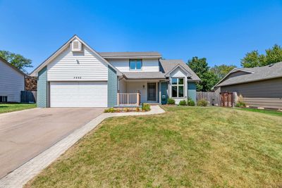 View of front of home with a front lawn and a garage | Image 1