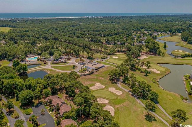 Aerial overview of property's location with a large body of water and a heavily wooded area | Image 30
