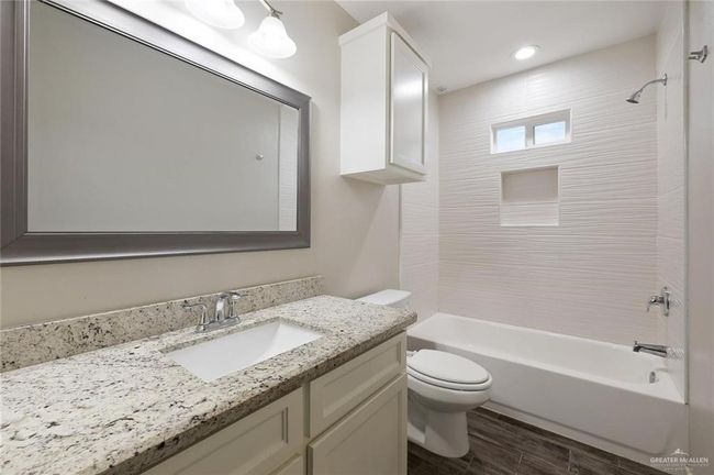 Bathroom with vanity, shower / tub combination, wood finished floors, and recessed lighting | Image 9