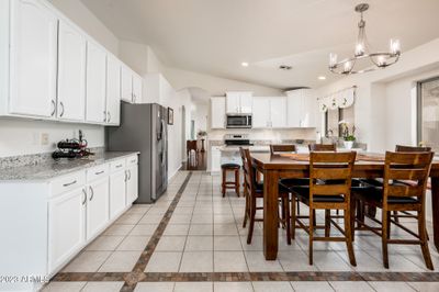 Next, here's the kitchen and the extra cabinets and counter space that surround an informal dining area. | Image 3