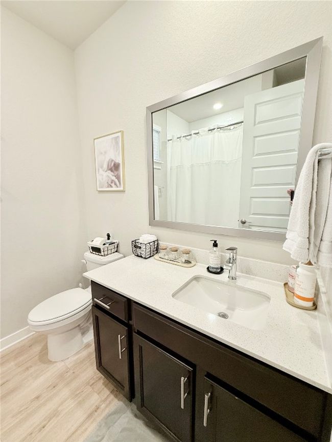 Bathroom with toilet, vanity, and wood finished floors | Image 32
