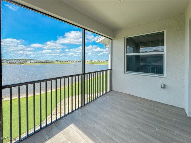 Unfurnished sunroom with a water view | Image 13
