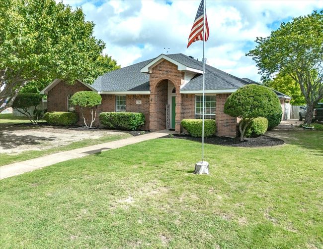 View of front of home featuring a shingled roof and brick siding | Image 38