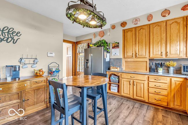 kitchen with backsplash and light wood finished floors | Image 25