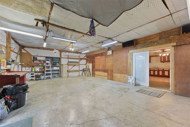 Includes Large Air compressor, Sand Blast cabinet, Built in Table saw, and Radial arm saw. With view of One Bedroom Apartment through French Doors. | Image 27