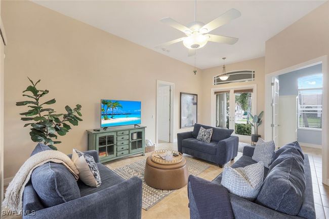 Living room featuring ceiling fan, french doors, and light tile patterned flooring | Image 5