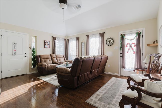 Living room with ceiling fan, dark hardwood / wood-style flooring, and high vaulted ceiling | Image 4