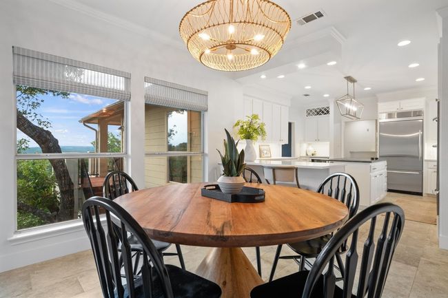 Dining space with crown molding, a chandelier, and recessed lighting | Image 11