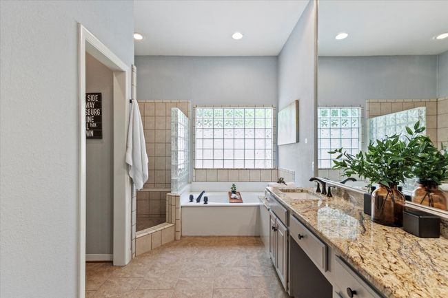Bathroom with vanity, a bath, a tile shower, and recessed lighting | Image 17