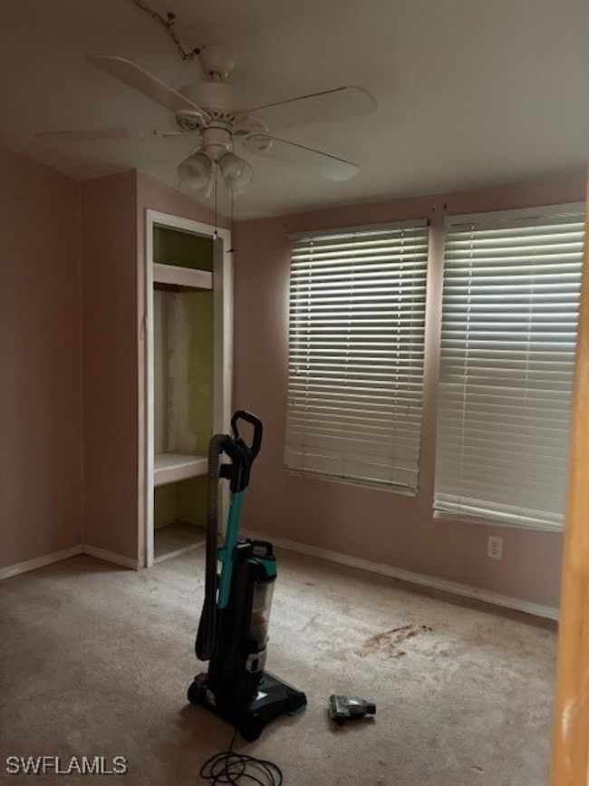 Workout room featuring carpet floors, a ceiling fan, and baseboards | Image 5