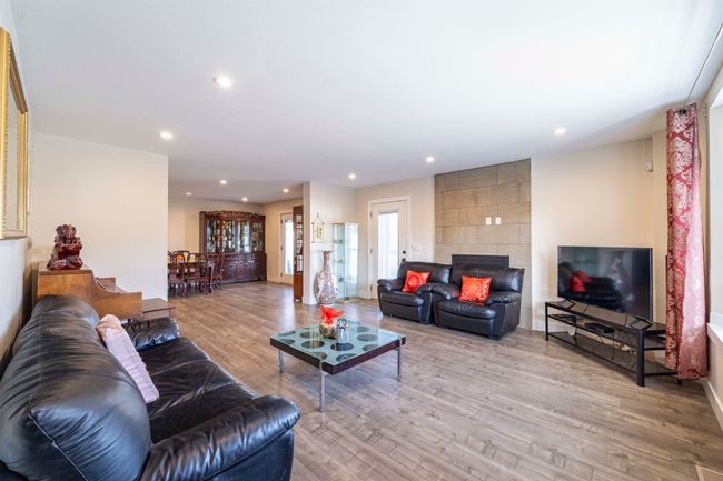 Living area with recessed lighting, light wood-style flooring, a fireplace, and baseboards | Image 4