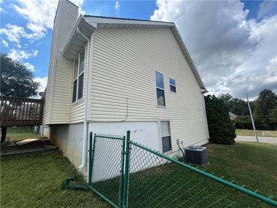 View of home's exterior with a lawn and central AC | Image 2