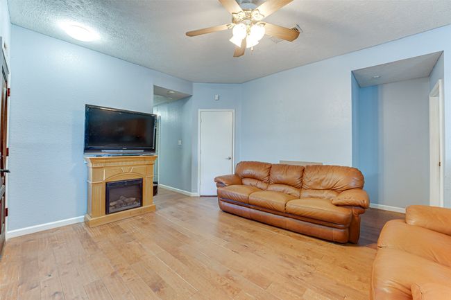 Living area featuring a ceiling fan, baseboards, and wood-type​​‌​​​​‌​​‌‌​‌‌​​​‌‌​​‌‌​‌​​​​​‌ flooring | Image 14