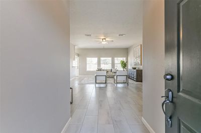 This front door welcoming view with new Tile and a Wall of Windows for natural lighting! | Image 2