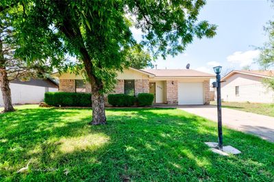 Single story home featuring a garage and a front yard | Image 2