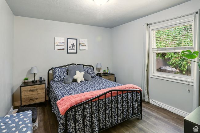 Bedroom featuring wood finished floors and baseboards | Image 16