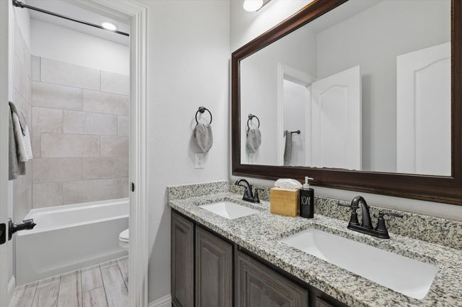 Downstairs Bathroom with door separating sink and tub/toilet | Image 29