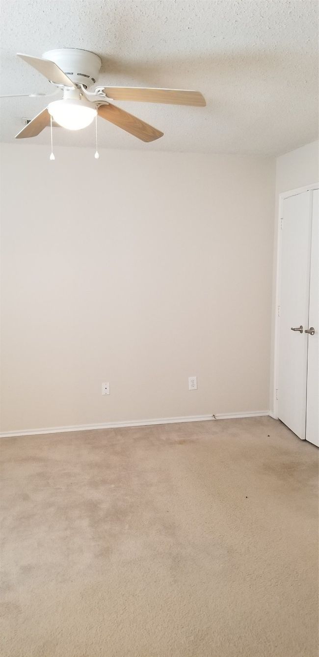 Unfurnished room featuring a ceiling fan and light carpet | Image 6