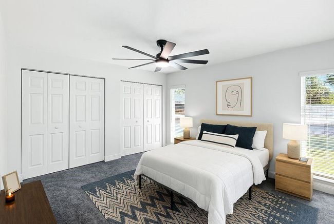 Virtually Staged -Tucked at the back of the home for added privacy, the primary suite is spacious and bright with double closets, direct access to the patio and backyard, and a private ensuite bath | Image 30