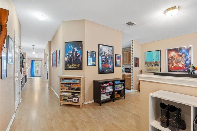 Hall with light wood-type flooring and baseboards | Image 7