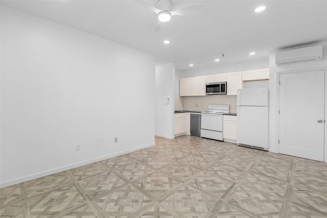 Open Concept Living Room/Kitchen with recessed lighting, a wall mounted ductless AC. | Image 4