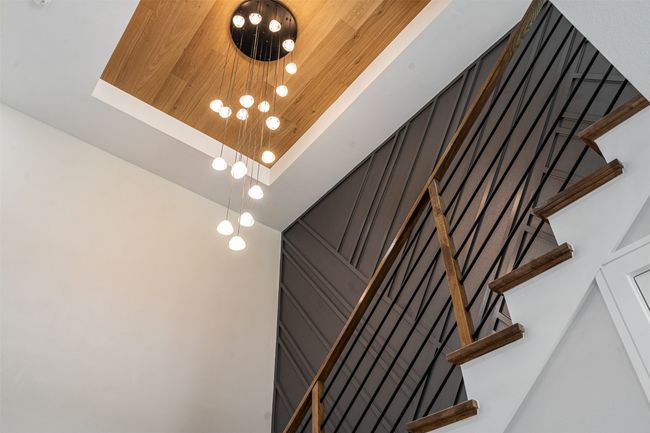 Staircase with wood art wall detail and stunning chandelier | Image 23