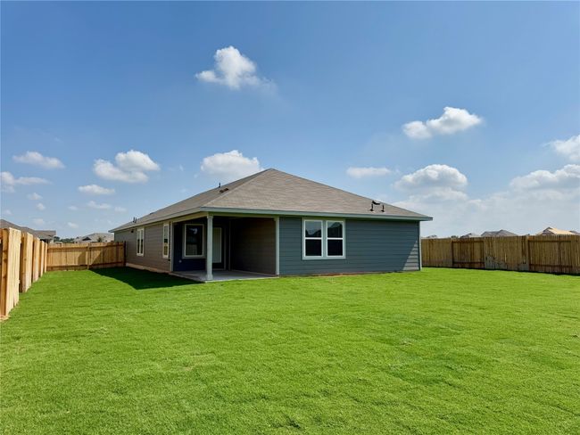Back of house featuring a fenced backyard, a patio, and a shingled roof | Image 5