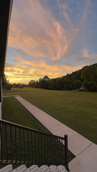 Sunset view from the Incredible bead board front porch perfect for morning coffee and entertaining | Image 3