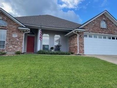 View of front of house featuring a front yard and a garage | Image 3