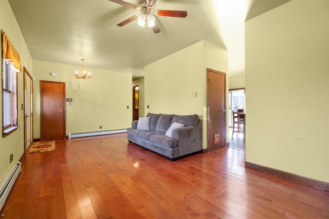 Living room with open flow into kitchen and dining area | Image 7