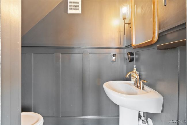 Half bathroom with a decorative wall and a sink | Image 21