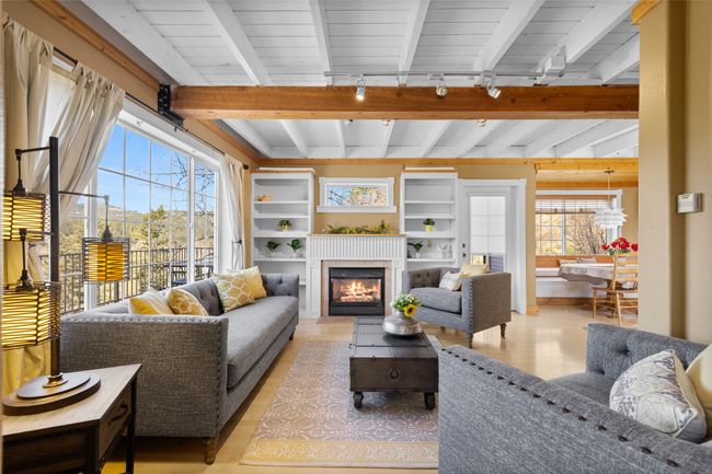 Living room featuring track lighting, a wealth of natural light, light wood-style floors, and beamed ceiling | Image 10