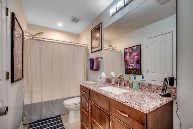 Bathroom featuring tub/shower combo and tile flooring | Image 26