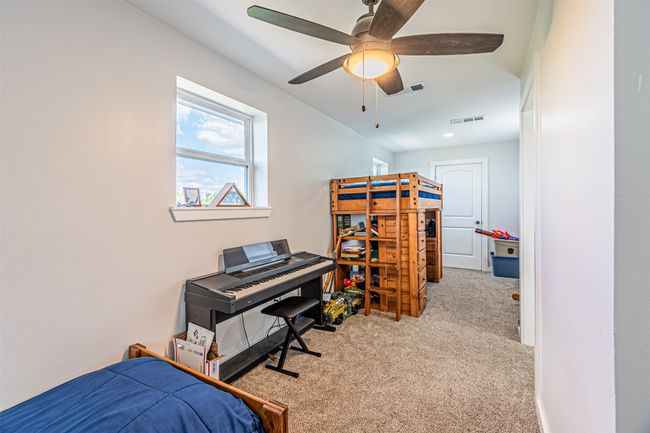 Bedroom with carpet floors and a ceiling fan | Image 31