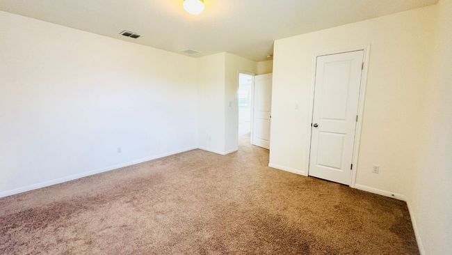 Unfurnished bedroom featuring light carpet and baseboards | Image 35