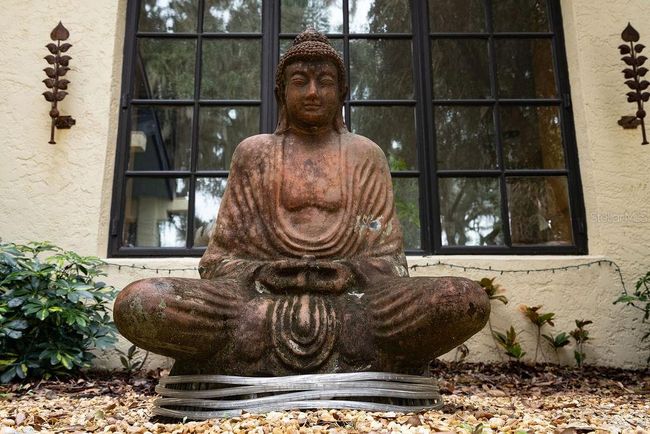 A meditative Buddha sets a tranquil tone as guests enter the courtyard. | Image 15