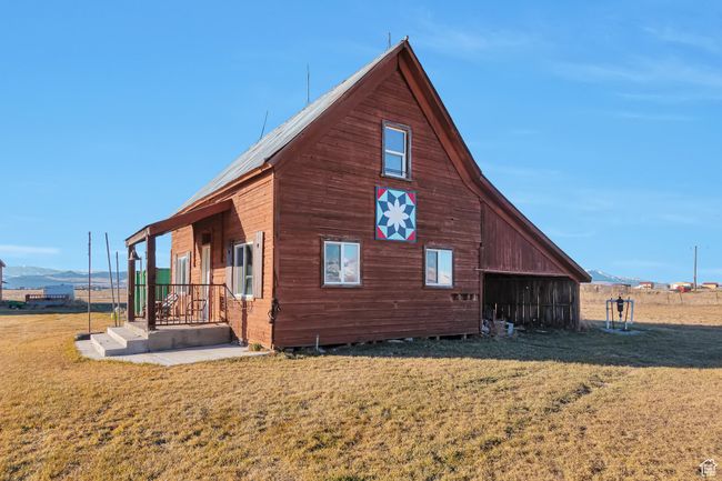 View of side of home featuring a lawn and a mountain view | Image 11
