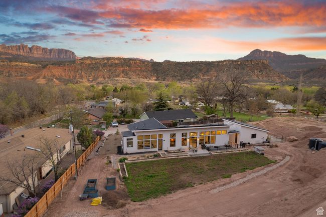 Exterior space with a mountain view, fence, and a patio area | Image 63