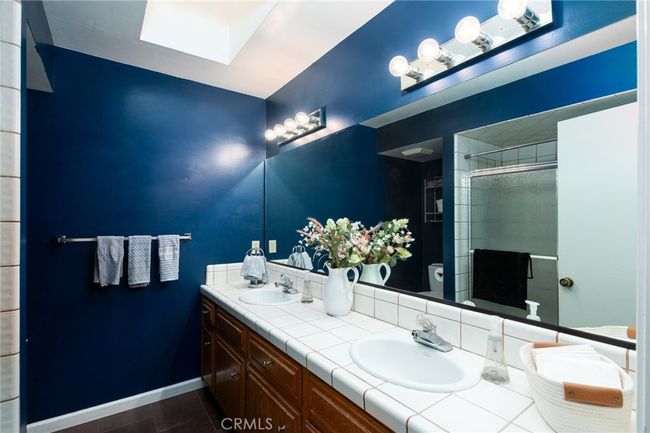 guest bathroom with tub/shower with skylight | Image 19